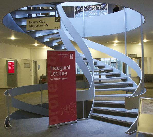 a photo of the lobby and a banner for the lecture